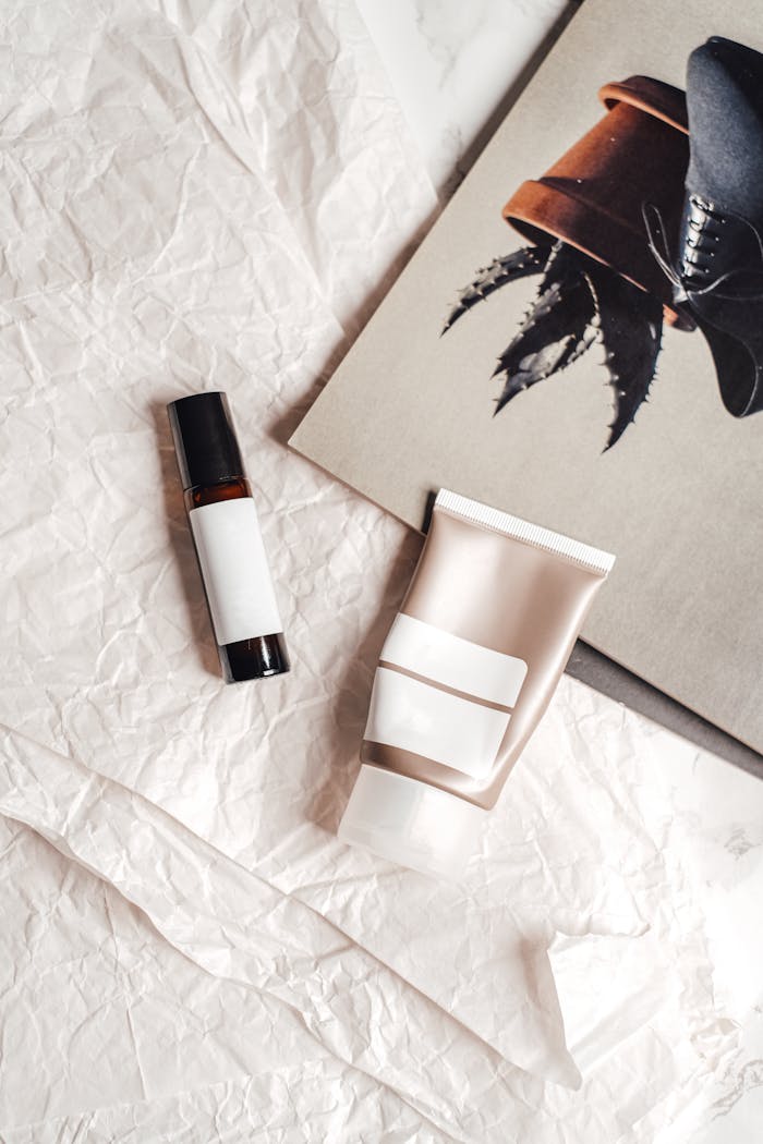 Flat lay of skincare products on crumpled paper with artistic background.